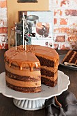 Chocolate cream cake with salted caramel, cut into pieces