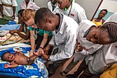 Hospital doctors examining babies