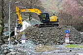 Diggers removing flood debris, UK