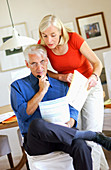 Senior couple reading paperworks