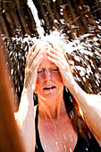 Woman taking outdoor shower