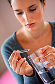 Woman with glass ampoule