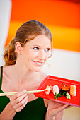 Woman eating sushi