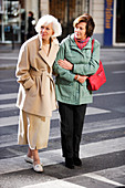 Woman assisting elderly person