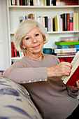 Elderly woman reading a book