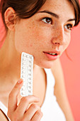 Woman holding contraceptive pills