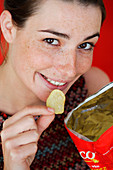 Woman eating potato chips