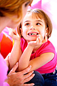 6 year old girl showing her milk teeth