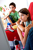 Children snacking and watching TV