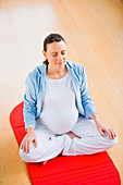 Pregnant woman practising yoga