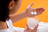 Woman taking an effervescent tablet
