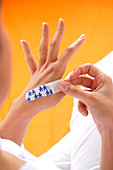 Woman putting a band-aid