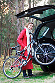 Woman carrying her bike