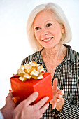 Elderly woman receiving a present