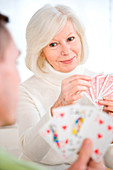 Elderly woman playing cards