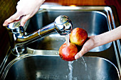 Woman washing fruit