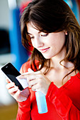 Woman cleaning her cell phone