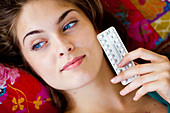 Woman with contraceptive pills