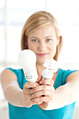 Woman holding energy saving bulbs