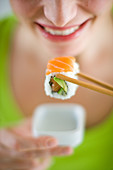 Woman eating sushi