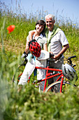 Senior couple riding tandem bicycle