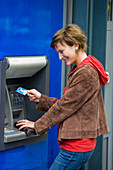 Young woman at cash machine