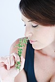 Woman inhaling thyme fragrance