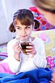 Child drinking in bed