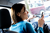 Woman using cell phone when driving