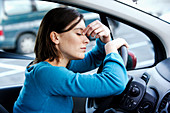 Tired woman in her car