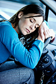 Tired woman in her car