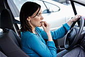 Stressed driver biting her nails