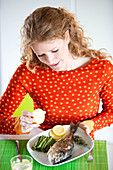 Woman eating fish