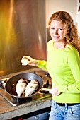 Woman cooking fish