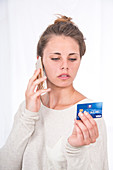 Woman on mobile phone with credit card
