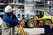 Construction site with man using theodolite
