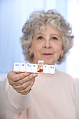 Woman holding pill organiser