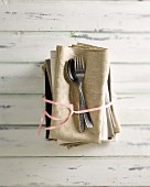 An old spoon with a fork on linen napkins