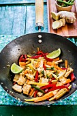 Chicken with ginger and vegetables in a wok (Asia)