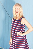 A blonde woman wearing a striped summer dress