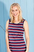 A blonde woman wearing a striped summer dress