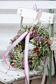 Autumn wreath with ribbon and lace trim on old chair