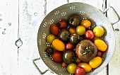 Different coloured tomatoes on a stand