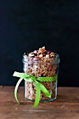 Almonds and cranberries homemade granola in a glass jar