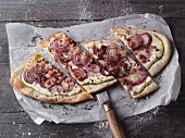 Alsace-style tarte flambée with red onions, quark and ham