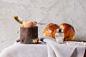 Breakfast with started eating soft-boiled egg in wooden eggcup and home made bread