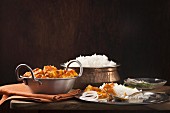 Paneer and sweet pepper curry with rice on wooden background