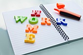 Colourful letters on notebook spelling homework