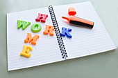 Colourful letters on notebook spelling homework