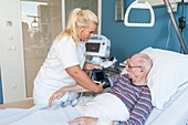 Nurse taking senior man's blood pressure